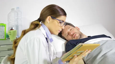 Sad man getting bad news about health in hospital from doctor medium shot Stock Footage 62897560