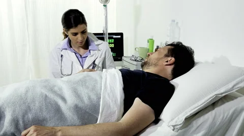 Sad man getting bad news about health in hospital from doctor Stock Footage 62899291