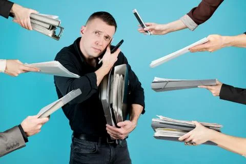 A sad man holds a bunch of documents in his arms Stock Photos