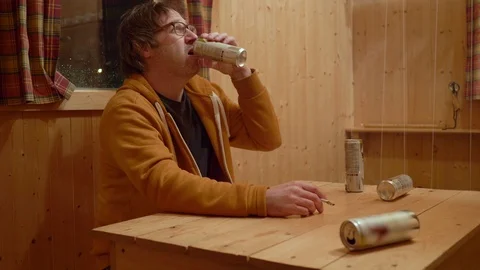 Sad Man Looking In Empty Wallet Smoking and Drinking at Kitchen Table Stock Footage 102610621