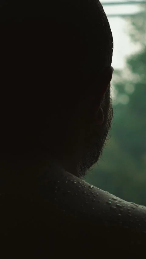 Sad man looking out window on rainy day Stock Footage 309835093