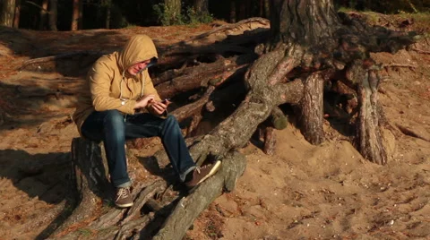 Sad man with phone on the beach Stock Footage 42770543