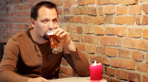 Sad man in pub drinking beer Stock Footage 1181107