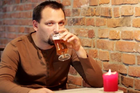 Sad man in pub drinking beer Stock Footage 1181112