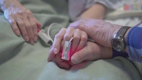 Sad man says good bye as wife dies Stock Footage 73440044