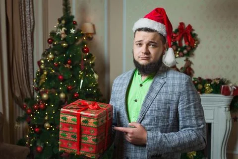 Sad man shows on the box with a gift Stock Photos