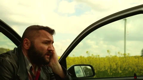 Sad man sits in car Stock Footage 62861717
