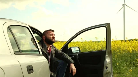 Sad man sits in car Stock Footage 62861733