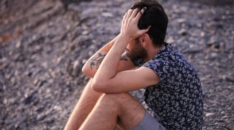 Sad man sitting on the beach 스톡 동영상 58243615