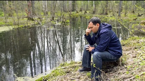 Sad Man Sitting by the Bog Stock Footage 76183788