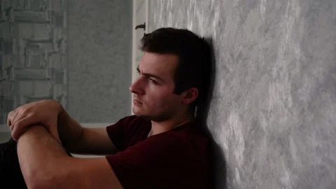 Sad man sitting in the corner of the wall Stock Footage 158835512