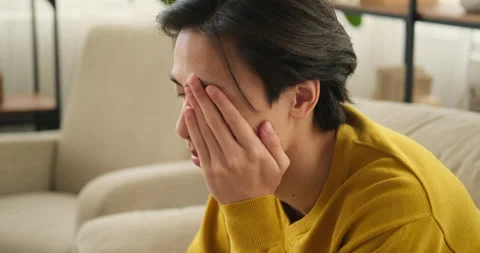 Sad man sitting on sofa at home Stock Footage 145294318