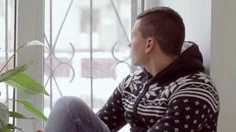 Sad man sitting on the window Stock Footage 56447495
