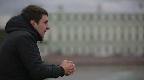 Sad man standing on the bridge in the center of St. Petersburg Stock Footage 44731697