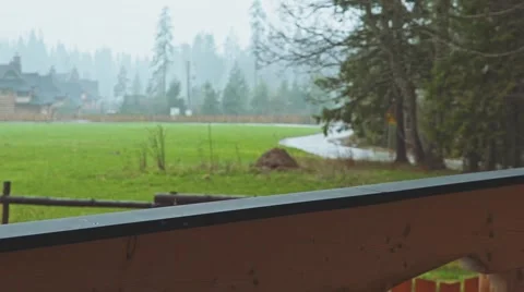 Sad Man is standing on the Terrace, Rain on Background. SLOW MOTION 120 fps. 動画素材 66757687