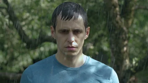 Sad man stands in the rain Stock Footage 132597652