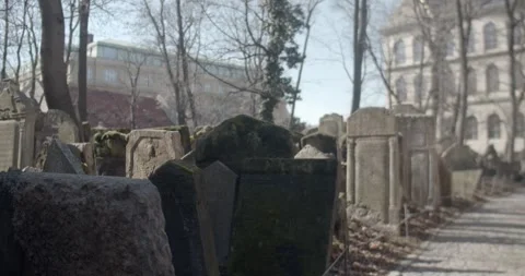 A sad man walks through the old Jewish cemetery in Prague Stock Footage 139499311