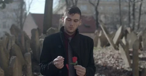 A sad man walks through the old Jewish cemetery in Prague Stock Footage 139499320