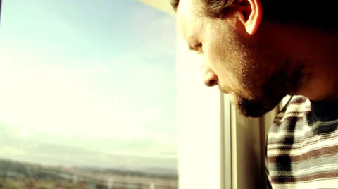 Sad man by the window Stock Footage 949013