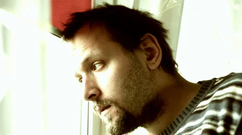 Sad man by the window Stock Footage 949099