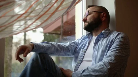 Sad man by the window Stock Footage 71658234