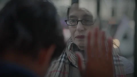 Sad Mother Saying Goodby to Son at Train Station Standing Behind Window Stock Footage 272184886