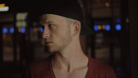 Sad nice guy in black cap looking away. Attractive gray-eyed student with beard Stock Footage 91149804