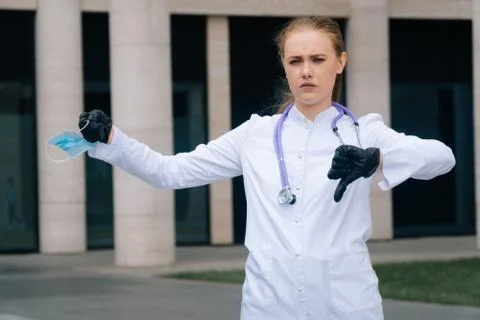 A sad, non-satisfied doctor shows his thumb down. Stock Photos
