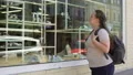 Sad obese female student looking at fashionable shoes in boutique, insecurities HD Footage
