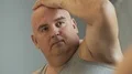 Sad obese male looking at his mirror reflection and thinking about problems HD Footage