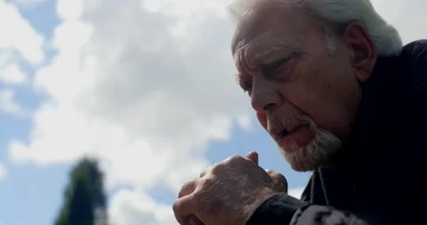 Sad old gray haired man prays on the sunny skyes background, religious people Stock Footage 168174409