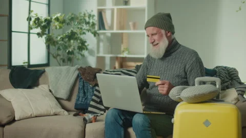 A Sad Old Man Makes a Purchase in the Online Store With a Credit Card. Video stock 244728817