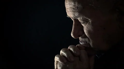 Sad old man praying in the darkness: sad old man, depressed old man, praying Video stock 56152291