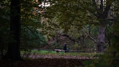 Sad old men sitting on bench in park alone. Video stock 142687072