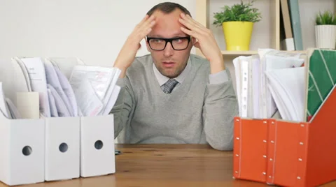 Sad, overwhelmed by too much paperwork businessman in the office HD Stock Footage 36669775