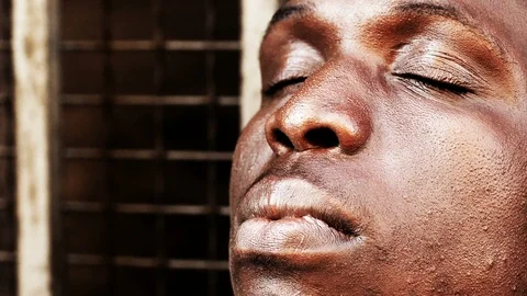 Sad pensive african man opens his eyes and looking the sky- hope,faith Stock Footage 88549082