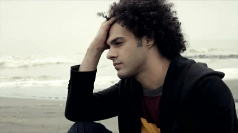 Sad pensive man on the beach in winter Stock Footage 49444292