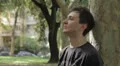 sad pensive man leaning on tree HD Footage