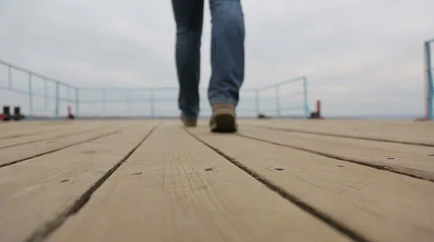 Sad pensive man walks on the pier Stock Footage 44444725