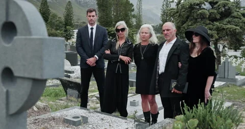 Sad, people and headstone at graveyard for funeral ceremony, burial service and Stock Footage 330912169