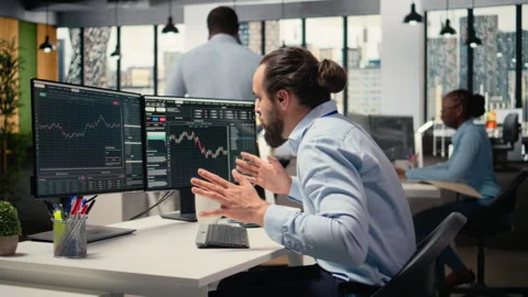Sad portfolio manager in office dejected by negative investment returns Stock Footage 315141547