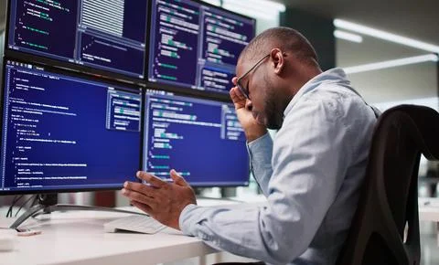 Sad Programmer Frustrated By Coding At Business Desk With Broken System. Stock Photos