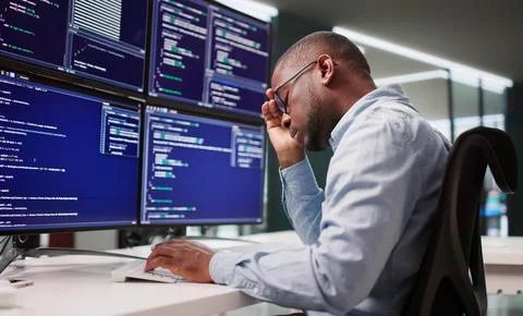 Sad Programmer Navigates Maze Of Broken Code At Business Desk. 스톡 사진