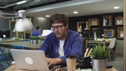 Sad programmer working on computer in office Stock Footage 121775812
