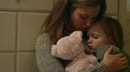 Sad, Scared Young Girl With A Stuffed Animal Being Held By Her Mother Stock Footage