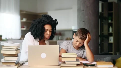 Sad school boy kid feeling upset while mother screaming because studying Stock Footage 248689663
