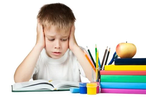 Sad schoolboy doing is homework Stock Photos