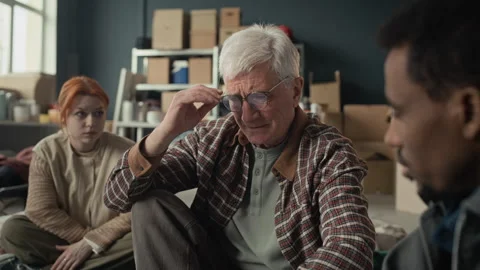Sad Senior Man Crying and Receiving Comfort from Diverse Volunteers Stock Footage 339069912