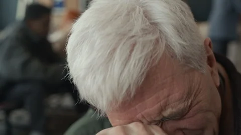 Sad Senior Man Removing Glasses and Crying in Humanitarian Aid Center Video stock 339073048