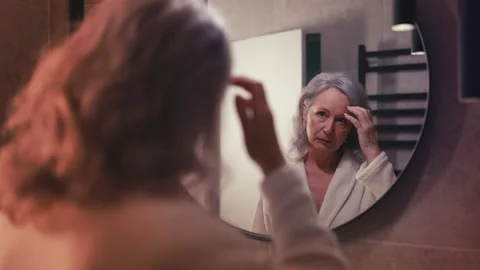https://images.pond5.com/sad-senior-woman-looking-mirror-footage-272626801_iconl.jpeg